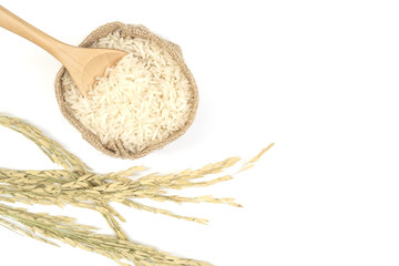 Rice in sack and wooden spoon on white background