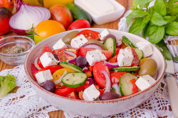 Greek salad with fresh vegetables, feta cheese and olives