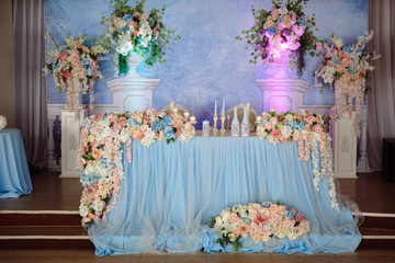 Beautiful decorated wedding restaurant for marriage. Colorful decoration for celebration. Beauty bridal interior. Concept of style of banquet hall