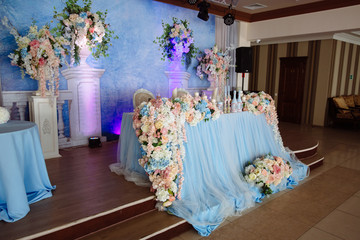 Beautiful decorated wedding restaurant for marriage. Colorful decoration for celebration. Beauty bridal interior. Concept of style of banquet hall
