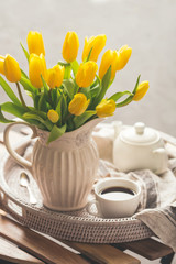 Yellow tulips and fresh tea
