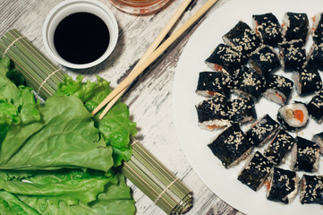 Sushi on the plate. Popular sushi japan food. Wooden rustic background. Top view
