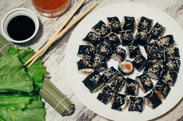 Sushi on the plate. Popular sushi japan food. Wooden rustic background. Top view