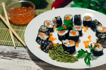 Sushi on the plate. Popular sushi japan food. Wooden rustic background. Top view