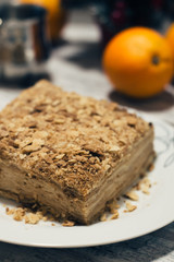 Slice of sweet classic layered cake Napoleon. Wooden rustic background. Top view.