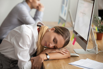 Exhausted young woman taking break to rest and having nap at workplace, tired of computer work businesswoman lying asleep at desk, employee sleeping dozing in office, lack of sleep overwork concept