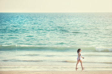 Woman walk on an empty wild beach