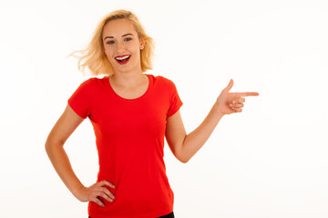 Fototapeta premium Attractive beautiful young blonde woman pointing into copyspace when advertising a product