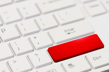 close up red button on white laptop keyboard