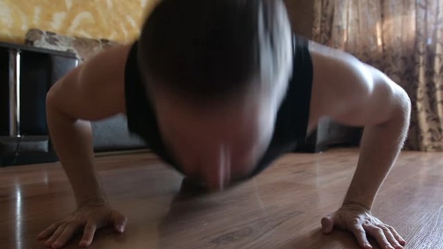 Sporty man doing push-up exercise at home