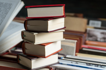 Many books in a bookstore or library on wooden background with copy space