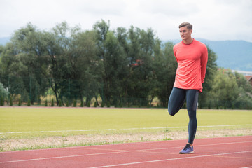 Young Fitness Man Runner Stretching Legs Before Run