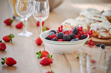 On the table are apetic baking and fresh berries
