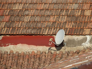 Isolated Grey Satellite Dish on Old Roof