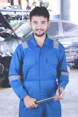 Young friendly mechanic smiling