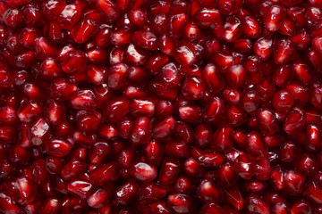 Background with seeds of fresh pomegranate fruit