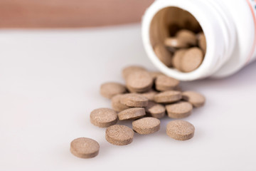 Tablets, a glass of pure water, a thermometer. On a white background.
