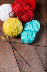 Knitting. Cloth strings on a wooden background. The concept of k