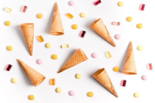 Ice cream cones and candy flat lay image with copy space.