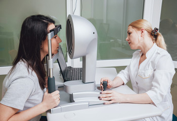 Optometrist is doing corneal topography. Corneal exam. Ophthalmology clinic