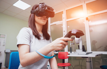 Eye treatment. Patient in virtual reality goggles. Checking the girl's vision with the help of...