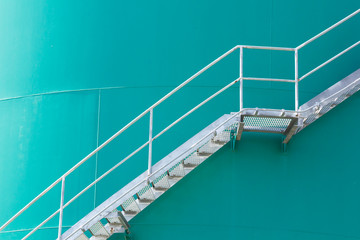 steel stair on  green metal silo,  metal ladder on green chemical container tank
