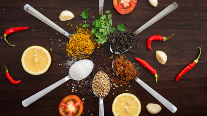 herbs and spices on wooden table top  -shot from above