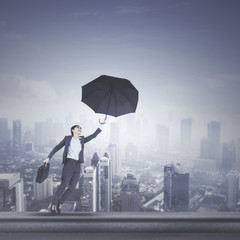 Beautiful manager with umbrella on rooftop