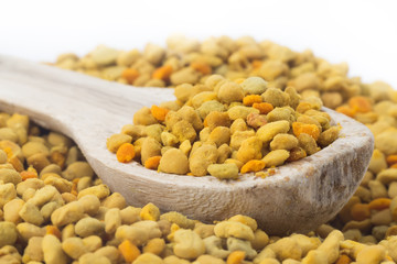 Flower bee pollen and a wooden spoon. Natural remedy for immunity enhancement. Beekeeping products. Apitherapy.