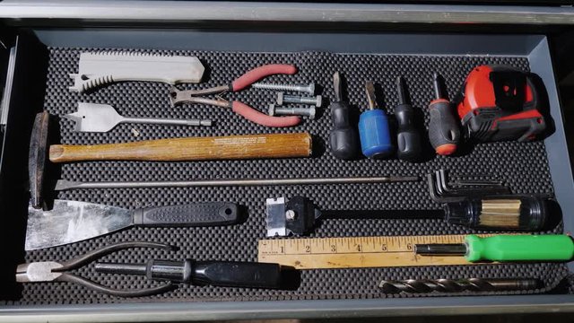 Male hands open a drawer with various hand tools. make a thing with your own hands concept, start-up
