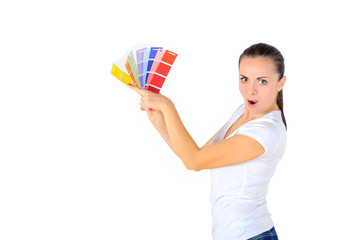 a girl with an amazed face chooses a color for repair in the room