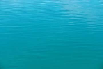 Crystal clear sea water texture, blue background