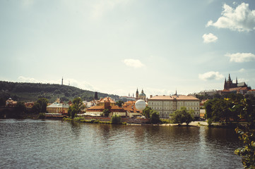 Fototapeta na wymiar historical architecture view across the river. Prague, Czech Republic