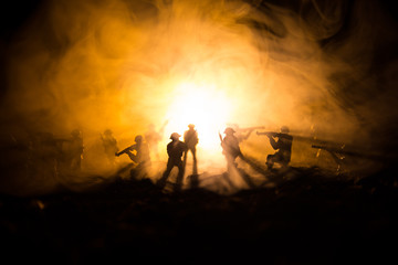 War Concept. Military silhouettes fighting scene on war fog sky background, World War Soldiers Silhouettes Below Cloudy Skyline At night. Attack scene. Armored vehicles. Tanks battle.