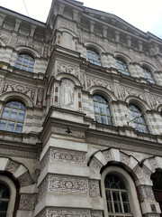 Facade of a beautiful art nouveau building in Prague covered in traditional sgraffito on the exterior. Looking up an beautifully decorated art nouvau architecture building in Prague.