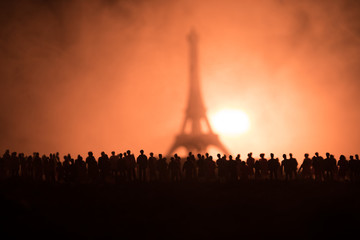 Silhouettes of a crowd standing at field behind the blurred foggy background. Revolution, people protest against government, man fighting for rights