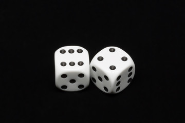 The dices are cast - two dices on a black background showing a total of ten eyes 