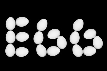 The word egg laid out with eggs on a black background