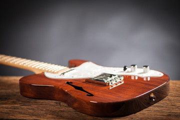 Close up of vintage electric guitar on a raw wood table. Musical instrument for jazz , rock and...