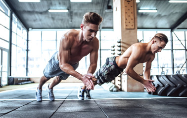 Naklejka na ściany i meble Strong men in gym