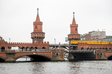 Fototapeta na wymiar U-Bahn train passing over Oberbaum Bridge in Berlin, Germany