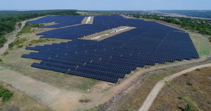 4K Aerial footage of photostatic solar farm. Solar farm power station from above. Ecological renewable energy.
