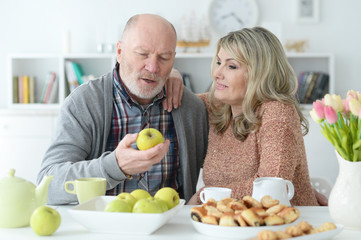 senior couple sitting at kitchen table