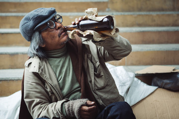 Potrait of homeless people sitting and drink alcohol