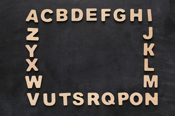 Wooden english letters on black background