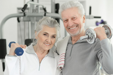 senior couple exercising in gym