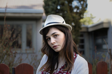 Portrait of a young woman with hat; close up, selective focus background.