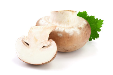 Royal Brown champignon with half and parsley leaf isolated on white background
