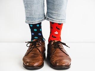 Male legs in bright, colorful socks and stylish, vintage shoes on a white background. Lifestyle,...