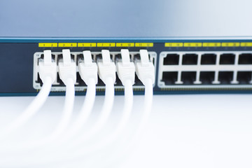 Corporate network concept. Set of ethernet switches, access points, cables, connectors, laptops on the white background. Top view. Space for a text. Close up.